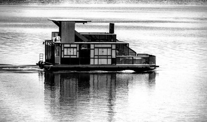 Exotic black and white boat sailing in calm lagoon © Adilson