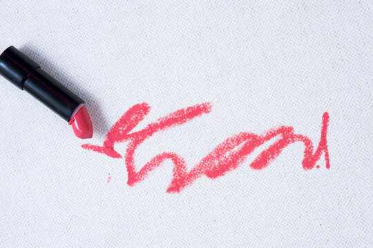 Broken lipstick. Dirty pink lipstick stains on a white background carpet and on upholstery. Cleaning of makeup stains. life stain concept. top view