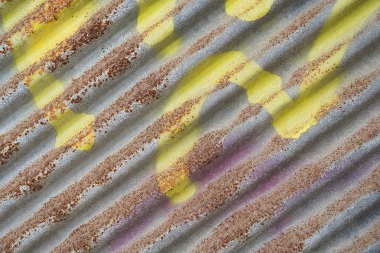 Rustic metal sheet with spray painted surface, rust background with diagonal lines, and abstract texture paint wallpaper
