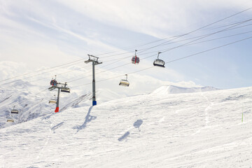 Gudauri Ski Resort: Gondola (Ski Lift) and Snow-covered Caucasus Mountains in Distance - Gudauri,...