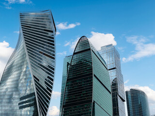 Obraz premium Tall office skyscrapers with sky reflection in windows, business concept banking background