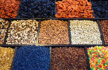 Market with oriental food, view of dried fruits, sweets and nuts at bazaar. Variety of natural...