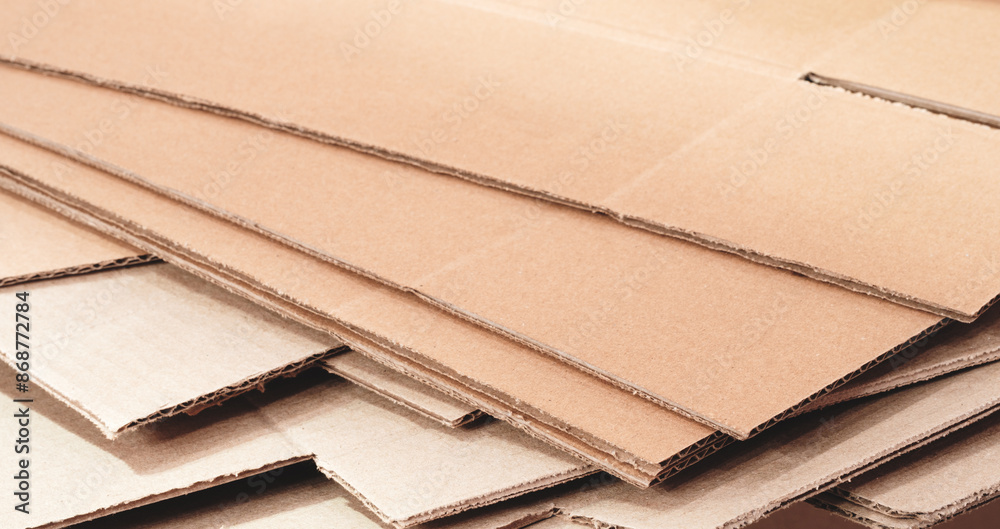 Poster cardboard is neatly placed in a stack for further use