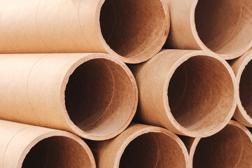 A stack of cardboard tubes as background. The tubes are brown and are arranged in a row