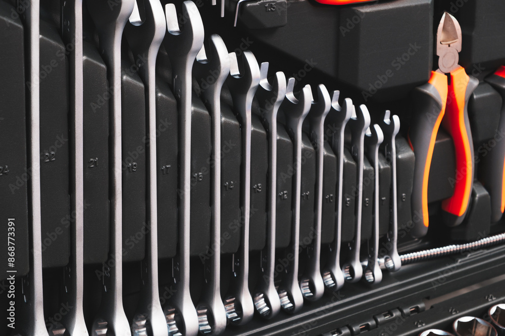 Poster A toolbox with many different tools including pliers, wrenches, and screwdrivers. The tools are organized in a way that makes it easy to find what you need