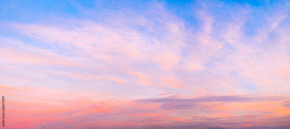 Poster a beautiful sunset with a red and blue sky. the sky is filled with clouds and the sun is setting