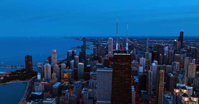 Lakefront of Lake Michigan in Chicago, Illinois, USA at twilight time. Fantastic scenery of the metropolis switching on lights at dusk. Top perspective.