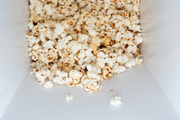 Sweet Popcorn Delight.  A close-up view inside a white popcorn bucket filled with sweet, crispy popcorn