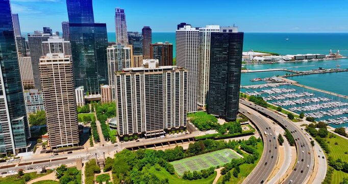 Fantastic green area near the gorgeous architecture of Chicago, Illinois, USA. Multiple yachts are at the waterfront pf the lake. Aerial view.