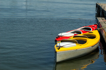 colored kayaks moored at the pier, water activities, outdoor recreation, lake