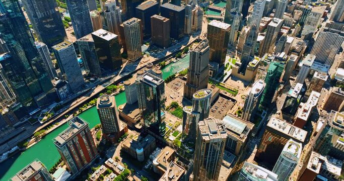 Sea-blue channel crossing the downtown of Chicago, IL, USA. Drone flying above the beautiful scenery of metropolis on sunny day.