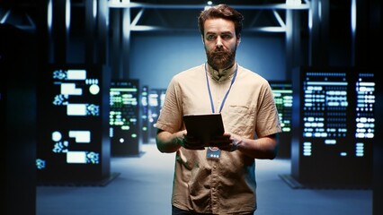 Computer scientist doing yearly checkup to extend data center electronics life span and avoid...