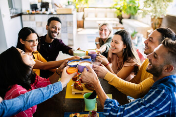 Young group of happy friends enjoying coffee during breakfast at cafeteria rooftop. Food and beverage concept