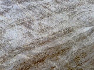 A polished granite marble kitchen surface exudes luxury and elegance, with its smooth, glossy finish and natural veining, enhancing any interior design with timeless beauty and sophistication.