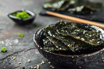 Traditional Japanese snack of crispy nori seaweed sheets served in a bowl with chopsticks