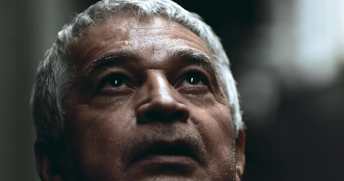 Hopeful senior man gazing upwards at sky with FAITH feeling the presence of GOD. Grateful elderly 70s close-up face of person looks up in contemplative awe
