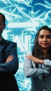 Vertical video Portrait of smiling team of technicians implementing artificial intelligence parallel processing, breaking up complex computational tasks enabling AI systems to process data faster