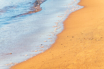 Soft wave of the sea on the sandy beach.