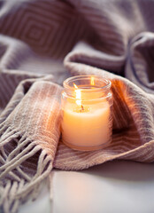 Enjoy the tranquil ambiance of a serene evening with cozy candlelight and a warm blanket fabric