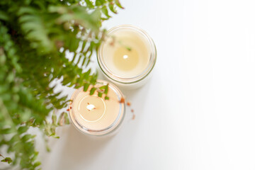 Create a visually appealing candle display with ferns for a harmonious, serene home decor