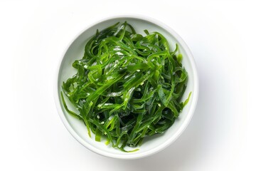 White bowl of Japanese seaweed salad isolated on top view
