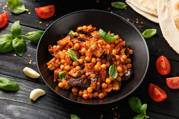 Eggplant and Chickpea Stew in tomato sauce, garlic, spices and pita bread. Healthy food