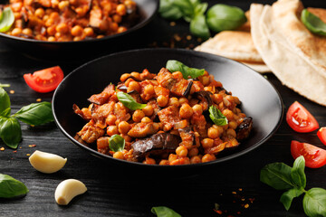 Eggplant and Chickpea Stew in tomato sauce, garlic, spices and pita bread. Healthy food
