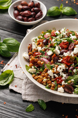 Lentil and Goats Cheese Salad with olives, onion, sun dried tomatoes and arugula. Healthy food