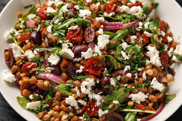 Lentil and Goats Cheese Salad with olives, onion, sun dried tomatoes and arugula. Healthy food