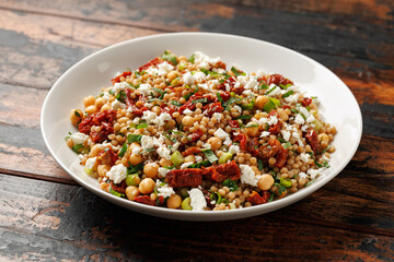 Pearl Couscous salad with sun dried tomatoes, chickpeas and feta cheese. healthy food