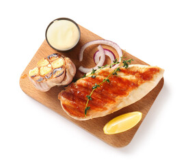 Wooden board of tasty grilled chicken breast with garlic, red onion, lemon and mayonnaise on white background