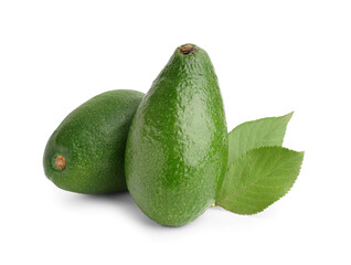 Fresh ripe avocados and leaves on white background