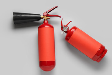 Fire extinguishers on grey background