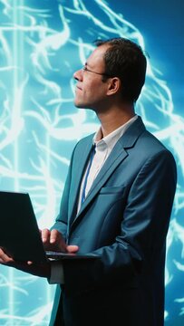 Vertical video Computer scientist using laptop to implement artificial intelligence parallel processing, breaking up complex computational tasks enabling AI systems to process more input data faster
