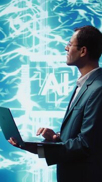 Vertical video Computer scientist using laptop to implement artificial intelligence parallel processing, breaking up complex computational tasks enabling AI systems to process more input data faster