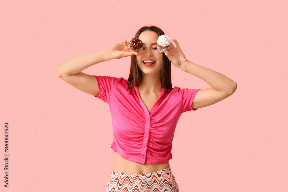 Canvas Prints Young woman with sweet cupcakes on pink background. Valentine's Day celebration