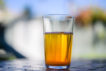 Orange paracetamol and salicylamid powder dissolved in a glass of water