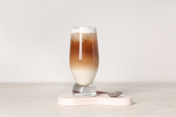 Glass of iced latte on white background