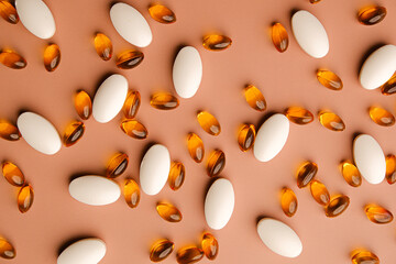 The pattern of vitamin and supplement on biege or neutal background.