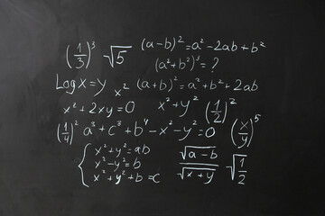 Different math formulas on black chalkboard