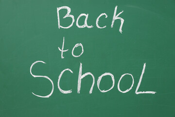 Text BACK TO SCHOOL written on green chalkboard