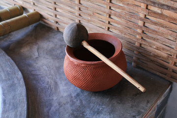 Clay pot and coconut dripper on concrete floor. Vintage Asian style water holder. Community products in the North and Northeast of Thailand In ancient times