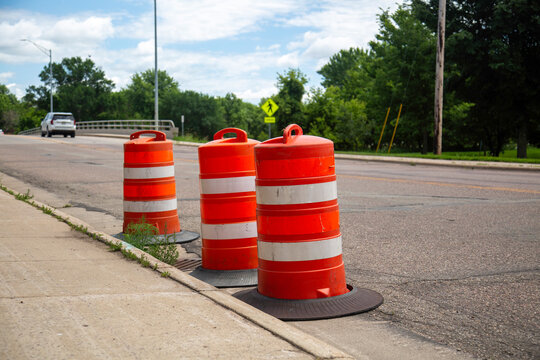 Orange Barrels Road Contruction Work, Yellow Cross Walk Sign, SUV Car Driving Across Des Moines River Bridge, Windom Minnesota Road Flooding Barrier, June 2024