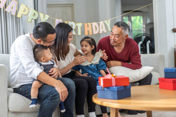 Portrait of happy love asian big family father and mother with asian baby and little girl happy birthday, party, celebration, cake, surprise, grandfather with grandmother smiling together.Family party