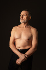 Fototapeta premium elderly man with a beard, a handsome torso and in good physical shape. Healthy lifestyle. Selective focus