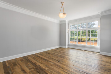 Bright Primary Bedroom With Large Windows And Elegant Wooden Flooring