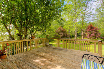 Wooden Deck In The Backyard With Surrounding Trees And Greenery