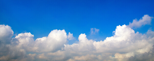Banner Tropical summer blue sky fluffy white cloud summertime on light sunny day cloudscape. Panoramic Clear bright blue skyline spring sunlight climate background. Heaven blue ecology for web banner