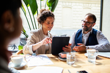 Business meeting in a cafe with diverse professionals