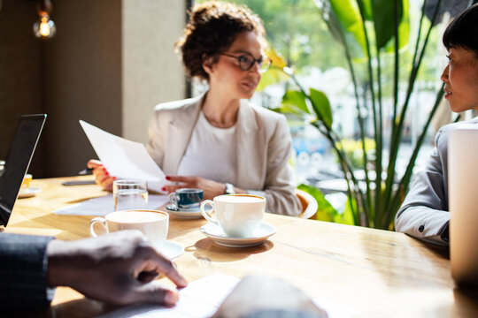 Business meeting in a cafe with diverse professionals